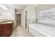 Bright bathroom featuring a soaking tub with tiled backsplash and a granite vanity at 337 Liberty Dr, Acworth, GA 30102