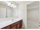 Bathroom vanity with wood cabinets, granite countertops, mirror, and entry to bedroom area at 337 Liberty Dr, Acworth, GA 30102