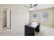 Bright bedroom featuring neutral paint and carpet, ceiling fan, and access to closet and bathroom at 337 Liberty Dr, Acworth, GA 30102