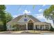 Inviting community clubhouse featuring stone accents, a covered entry, and lush landscaping at 337 Liberty Dr, Acworth, GA 30102