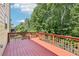 Home exterior featuring a red wood deck that overlooks lush trees at 337 Liberty Dr, Acworth, GA 30102