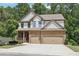 Charming two-story home featuring a stone and siding facade, a two-car garage, and a welcoming front porch at 337 Liberty Dr, Acworth, GA 30102