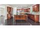 Spacious kitchen with dark wood cabinets, stainless steel appliances, granite countertops and a center island at 337 Liberty Dr, Acworth, GA 30102