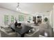 Bright, open-concept living and dining area with fireplace, hardwood floors, and access to the outdoor deck at 337 Liberty Dr, Acworth, GA 30102