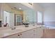 Elegant bathroom featuring double sinks, a large mirror, and a soaking tub at 12955 Mariners Ct, Alpharetta, GA 30005