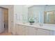 Bright bathroom boasts double sinks with white cabinets at 12955 Mariners Ct, Alpharetta, GA 30005