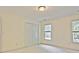 Bright bedroom features double closets, two windows, and neutral carpet at 12955 Mariners Ct, Alpharetta, GA 30005
