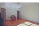 Bright bedroom featuring hardwood floors, ceiling fan, and natural light at 12955 Mariners Ct, Alpharetta, GA 30005