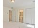 Bedroom view featuring ensuite bath, walk-in closet, and views to the hallway at 12955 Mariners Ct, Alpharetta, GA 30005