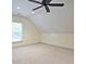 Attic bedroom with ceiling fan, dormer window and lots of carpeted floor space at 12955 Mariners Ct, Alpharetta, GA 30005