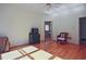 Spacious bedroom with hardwood floors, natural light, and ceiling fan at 12955 Mariners Ct, Alpharetta, GA 30005