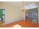 Bright dining room with hardwood floors, chandelier, and access to the kitchen and living room at 12955 Mariners Ct, Alpharetta, GA 30005