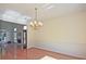 Bright dining room with hardwood floors, chandelier, and access to the living room offers abundant natural light at 12955 Mariners Ct, Alpharetta, GA 30005