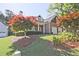 Charming brick home with well-maintained landscaping, two-car garage, and mature trees at 12955 Mariners Ct, Alpharetta, GA 30005