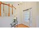 Inviting foyer with hardwood floors, staircase, and glass table with decor at 12955 Mariners Ct, Alpharetta, GA 30005