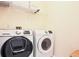 Bright laundry room featuring new Samsung washer and dryer with shelving at 12955 Mariners Ct, Alpharetta, GA 30005