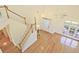 Bright living room with hardwood floors, high ceilings, large windows, and a staircase creates a bright and airy feel at 12955 Mariners Ct, Alpharetta, GA 30005
