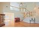 Bright living room with hardwood floors, staircase, and large windows offers abundant natural light at 12955 Mariners Ct, Alpharetta, GA 30005