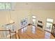 Open living room with fireplace, hardwood floors, large windows, and high ceilings creates a bright and airy feel at 12955 Mariners Ct, Alpharetta, GA 30005