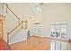 Elegant living room with hardwood floors, staircase, and large windows with natural light at 12955 Mariners Ct, Alpharetta, GA 30005