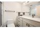 Bathroom featuring an extended vanity with drawers for storage, with a toilet at 199 14Th St # 2502, Atlanta, GA 30309
