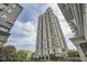 View of high-rise condo building with balconies against a cloudy sky at 199 14Th St # 2502, Atlanta, GA 30309