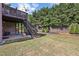 Spacious backyard featuring a patio, steps to a deck, and a lush lawn at 4630 Carriage Walk Ln, Cumming, GA 30040