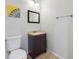 Bathroom with a white toilet, vanity, framed mirror, and updated lighting at 4630 Carriage Walk Ln, Cumming, GA 30040
