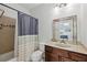 Cozy bathroom with a shower, toilet, vanity, mirror and tan and white color scheme at 4630 Carriage Walk Ln, Cumming, GA 30040