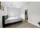 Simple bedroom with a bed, neutral carpet, and a view into the ensuite bathroom at 4630 Carriage Walk Ln, Cumming, GA 30040