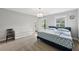 Bedroom with light gray walls, carpet, and a full size bed next to windows providing natural light at 4630 Carriage Walk Ln, Cumming, GA 30040