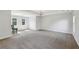 Spacious bedroom with carpet, natural light from dual windows, and a modern chandelier at 4630 Carriage Walk Ln, Cumming, GA 30040