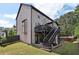 Back exterior view of a two-story home with deck, patio, and backyard at 4630 Carriage Walk Ln, Cumming, GA 30040