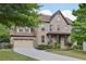 Charming brick two-story home with attached two-car garage and landscaped front yard at 4630 Carriage Walk Ln, Cumming, GA 30040