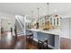 Bright kitchen featuring marble countertops, stainless steel appliances, pendant lighting, and a breakfast bar with seating at 4630 Carriage Walk Ln, Cumming, GA 30040