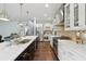 Gourmet kitchen with stainless steel appliances, white cabinets, a center island, and hardwood flooring at 4630 Carriage Walk Ln, Cumming, GA 30040