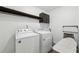 Functional laundry room equipped with a Whirlpool washer and dryer set at 4630 Carriage Walk Ln, Cumming, GA 30040