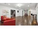 Spacious living room with hardwood flooring, leading to dining and recreation areas at 4630 Carriage Walk Ln, Cumming, GA 30040