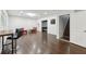 Open living space with hardwood floors, bar table, and a stairwell at 4630 Carriage Walk Ln, Cumming, GA 30040