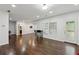Open-concept living room with hardwood floors, recessed lighting, and natural light at 4630 Carriage Walk Ln, Cumming, GA 30040