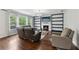 Comfortable living room with fireplace, built-in bookshelves, and large windows at 4630 Carriage Walk Ln, Cumming, GA 30040
