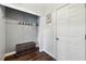 Neat mud room with a bench, hooks, and hardwood flooring, offering practical storage space at 4630 Carriage Walk Ln, Cumming, GA 30040
