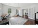Well-lit home office with hardwood floors, large windows, and French doors at 4630 Carriage Walk Ln, Cumming, GA 30040