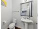 Cozy powder room features pedestal sink, framed mirror, and modern fixtures at 4630 Carriage Walk Ln, Cumming, GA 30040