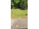 View from the patio onto a large backyard with lush greenery and a quaint gazebo at 65 King James Se Ct, Conyers, GA 30013