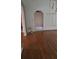 Spacious living room area with hardwood floors and a unique architectural archway at 65 King James Se Ct, Conyers, GA 30013