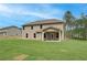 Expansive backyard showcasing a two-story home with a covered porch and lush green lawn at 100 Bree Dr, Fayetteville, GA 30214