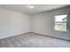 Well-lit bedroom features plush carpeting and single window at 100 Bree Dr, Fayetteville, GA 30214