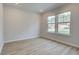 Neutral bedroom featuring recessed lighting, wood floors, and natural light from two windows at 100 Bree Dr, Fayetteville, GA 30214