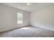 Bright bedroom featuring neutral walls, plush carpet, and a sunlit window at 100 Bree Dr, Fayetteville, GA 30214